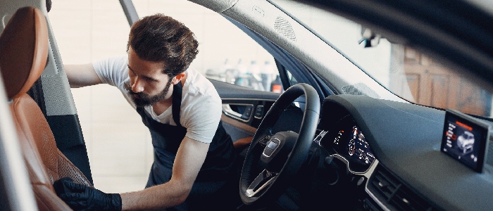man-polishing-car-inside-car-service